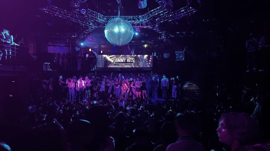 A mirror ball over a crowded dance floor