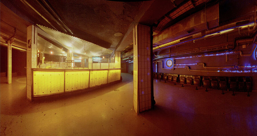 An empty, warmly lit club bar before opening
